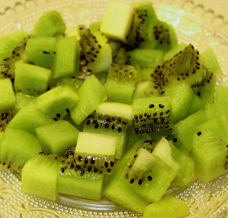 chopped green kiwi fruit with black seeds on dish