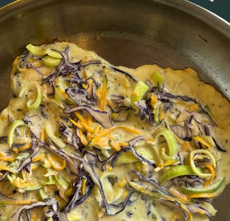 shredded vegetable pancake in frying pan