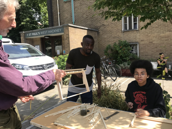 Beekeeper Eric with Kwame and Anokye making hives at the farmers' market