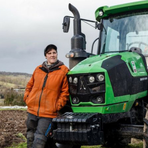 Farmer with tractor on organic farm