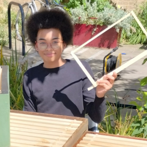 Anokye with his first beehive frame