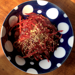 kimpira beetroot in blue bowl with large white spots 