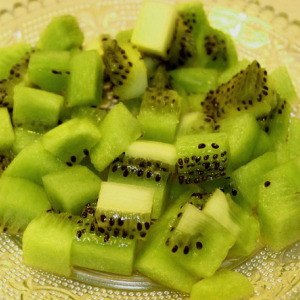 chopped green kiwi fruit with black seeds on dish