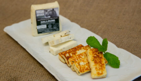 slices of cooked and uncooked organic English halloumi from Sussex on a white board