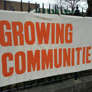 fabric banner with GROWING COMMUNITIES in orange capital letters